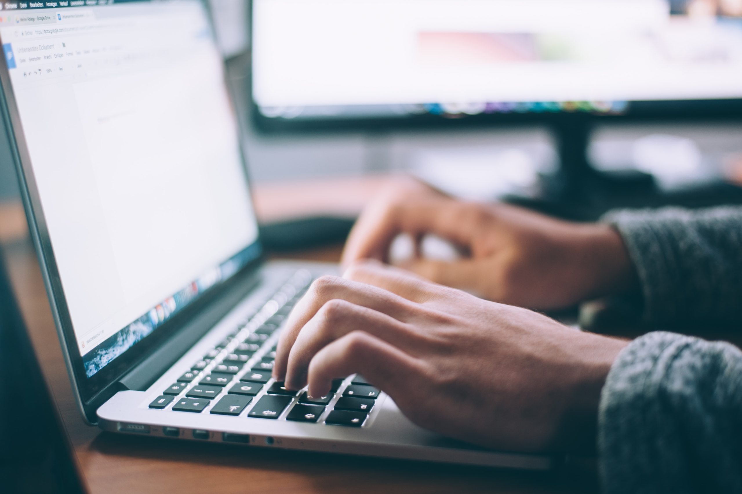 Image of a person typing on a computer. Photo by Glenn Carstens Peters / Unsplash